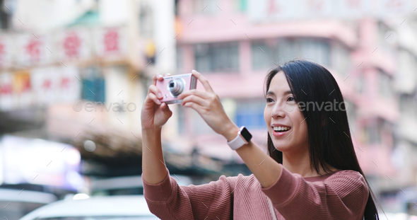 Woman take photo on camera in the city - Stock Photo - Images