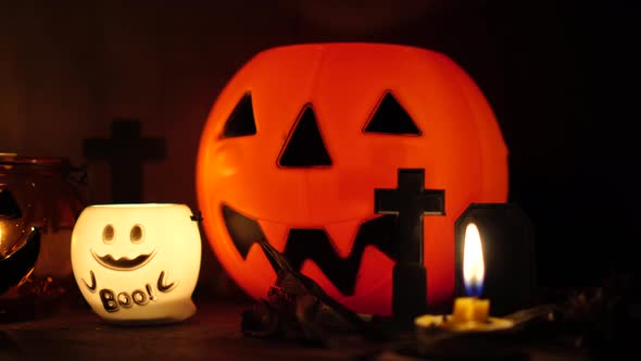 The concept of the Halloween festival with the orange pumpkin, candle light, and the bone skull alt