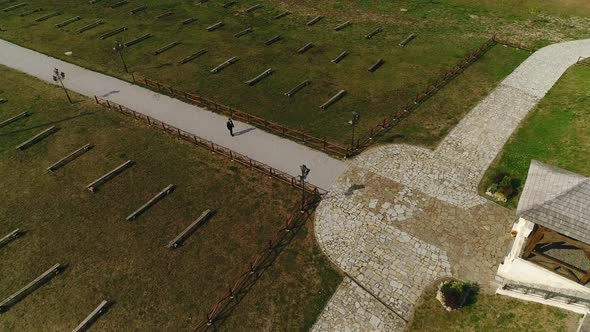 A Lone Groom Walks Down the Aisle Among Empty Benches Without Spectators