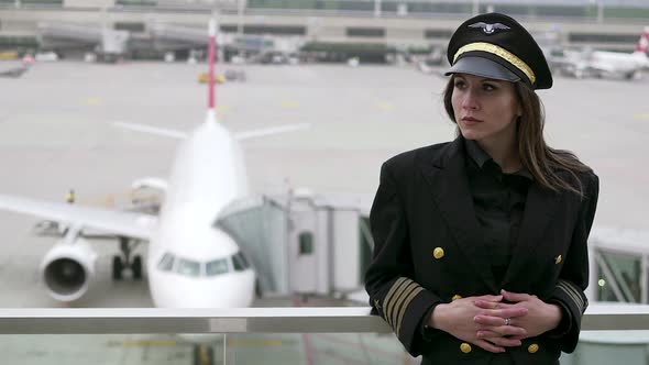 Professional Female Pilot in Uniform at Airport alt