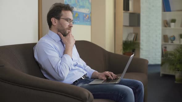 Serious Man With Laptop Thinking How to Make Extra Money, Modern Technologies alt