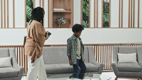 Woman and Child Entering Reception Room alt