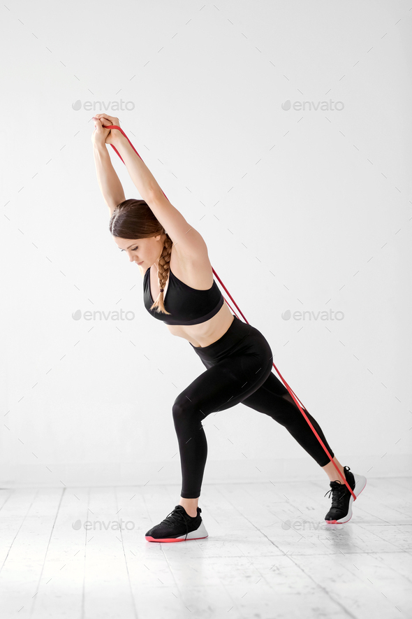 Athletic woman working out with power band