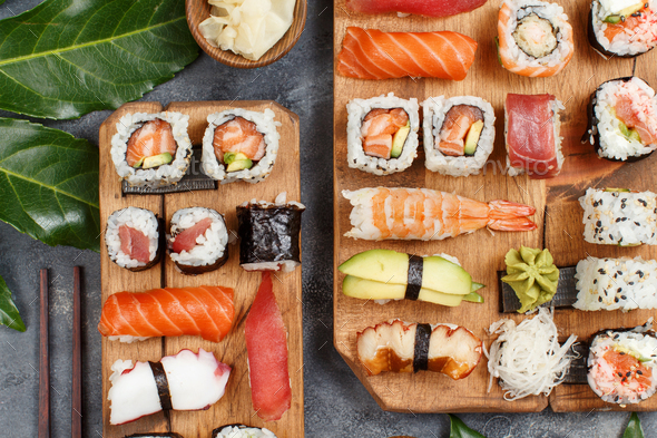 Sushi Set nigiri and sushi rolls on rectangular wooden plates