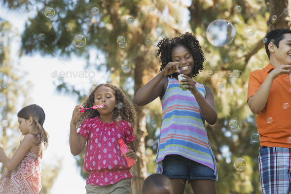 Children playing outdoors in summer - Stock Photo - Images