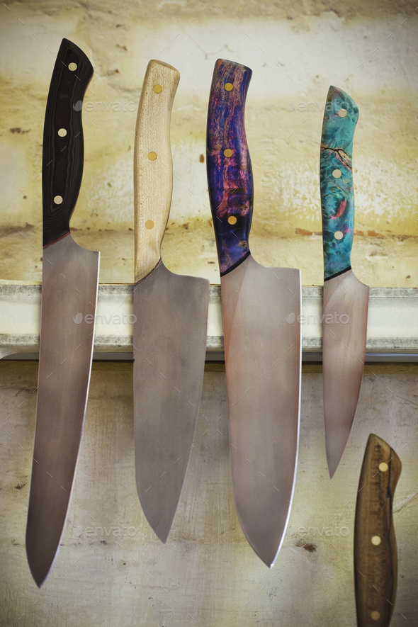 Knives on magnetic rack in commercial kitchen Stock Photo by Mint_Images
