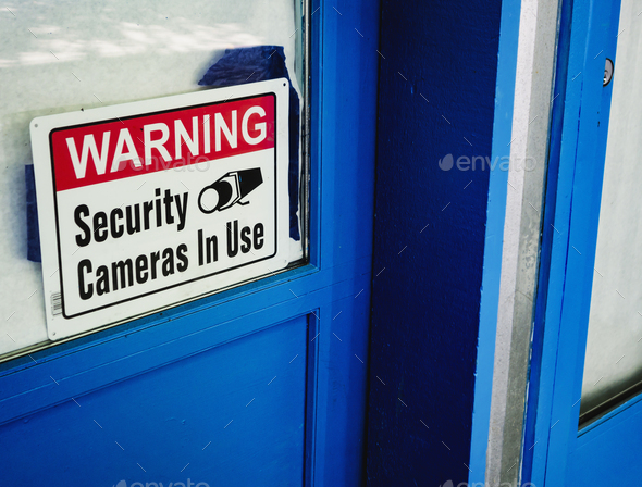 Security camera sign in a shop window.