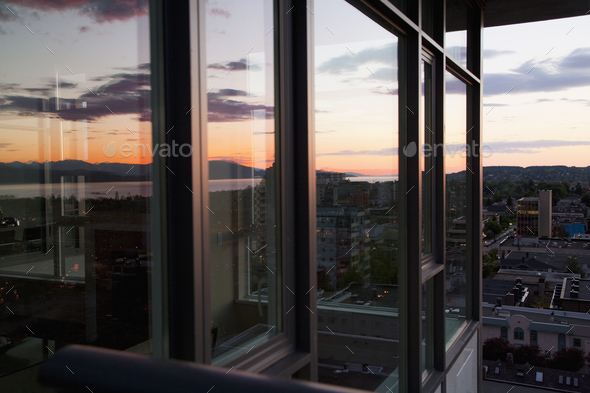City view at dusk from an open window in an apartment - Stock Photo - Images