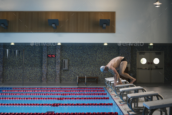 Man diving into indoor swimming pool, series - Stock Photo - Images