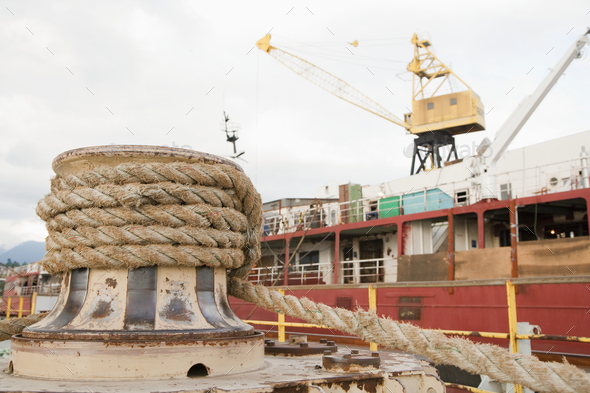 Seaport, dockside, large boat moored, thick ropes Stock Photo by Mint_Images