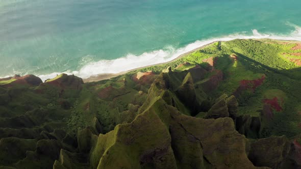 Cinematic Aerial Beautiful Green Ocean Coast with Amazing Green Peaks at Sunset alt
