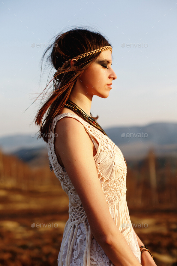 beautiful boho woman relaxing in sunny evening on top of a mountain - Stock Photo - Images