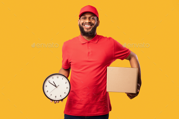 African Courier Holding Parcel And Clock Posing Over Yellow Background