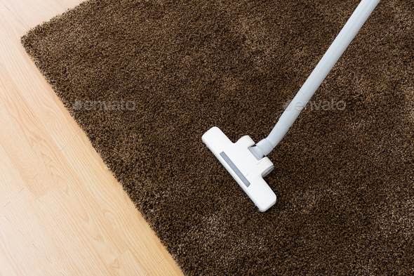 Head of modern vacuum cleaner on carpet