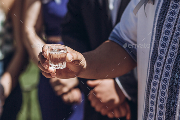 People drinking vodka during celebration hands closeup