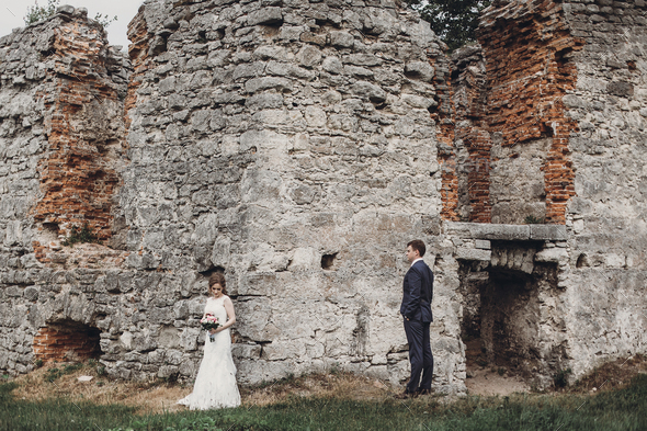 happy wedding couple hugging and embracing at old castle Stock Photo by ...