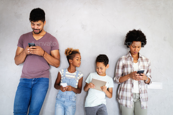 Family, technology concept. Happy african american family using technical devices, phone, tablet