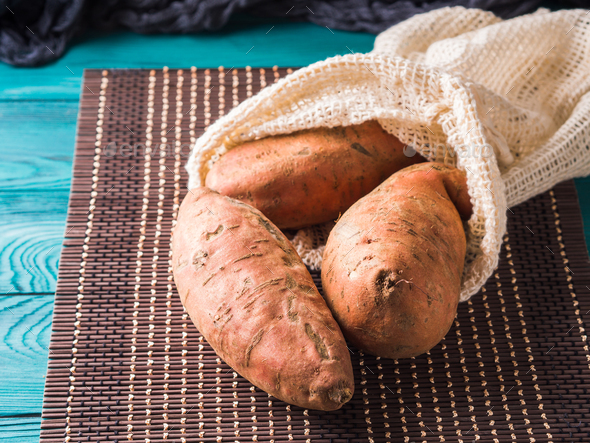 Sweet potato in a reusable cotton mesh bag - Stock Photo - Images
