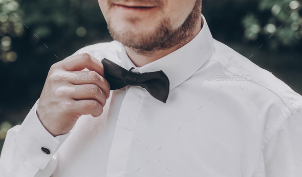 white shirt with black bow tie ...