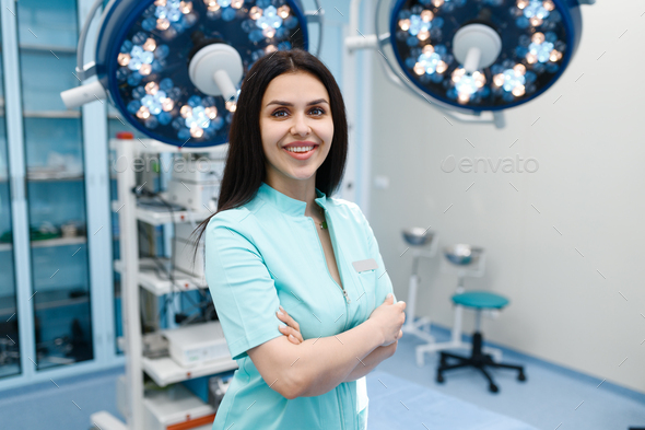 Smiling female surgeon in operating room Stock Photo by NomadSoul1