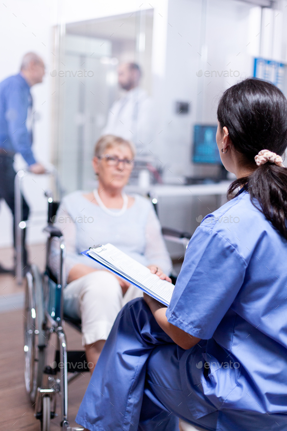 Nurse talking with handicapped - Stock Photo - Images