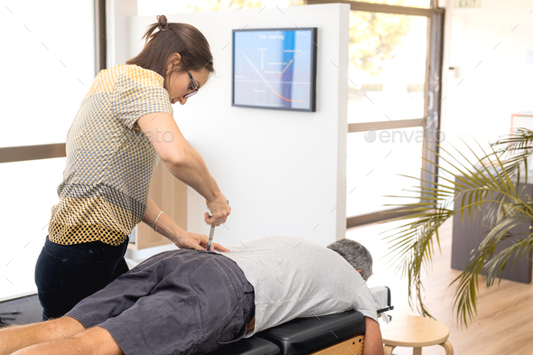 Man having chiropractic back adjustment. Physioterapy, osteopathy, alternative medicine pain relief rehabilitation