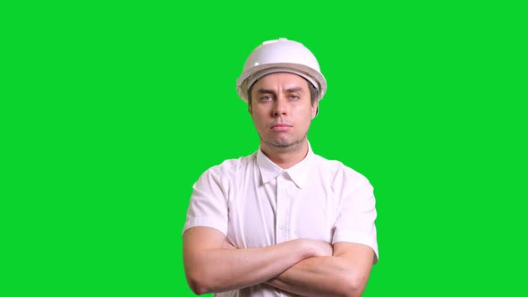 Young Male Engineer Standing and Smiling on Green Screen Background alt