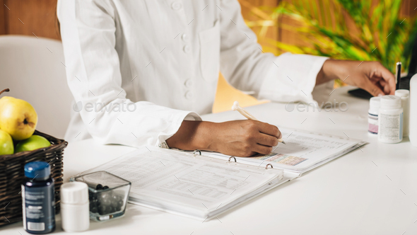 Functional Medicine Doctor Taking Notes for Personal Health Report
