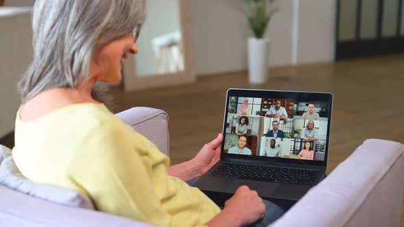 Grayhaired Senior Woman Using Online Platform for Online Communication with Colleagues alt