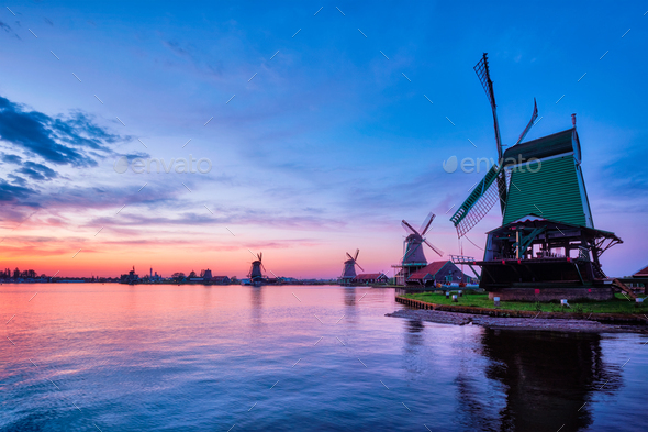 Windmills at famous tourist site Zaanse Schans in Holland with dramatic sky. Zaandam, Netherlands - Stock Photo - Images