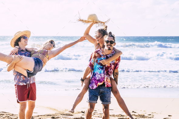 Happy group of caucasian young people at the beach - Stock Photo - Images