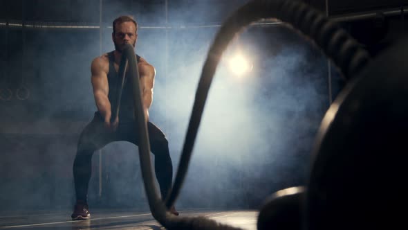 Man Workout with Ropes in a Gym Low Angle, Close-up of Kettlebell. Slow Motion 