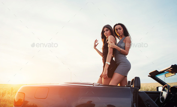 Stylish hipster arab man guy in hat posed outdoor in street against his  black muscle car and speaking on mobile phone Stock Photo - Alamy