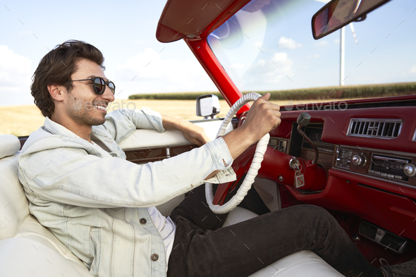 Side view of happy man driving an old car Stock Photo by gpointstudio