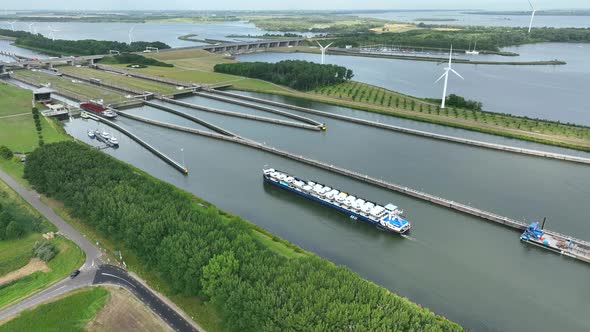 Vehicles Transported by Boat Entering the Volkerak Lock in the Netherlands alt