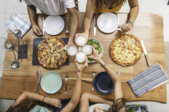Top View of Friends Cheering With Beers and Having Pizzas - Stock Photo - Images