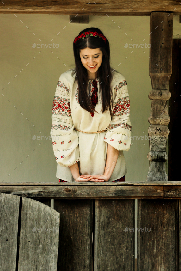 beautiful brunette woman in national ukrainian embroidery clothes