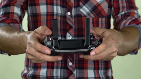 Man in a Controls the Remote Control From the Computer. Close Up alt