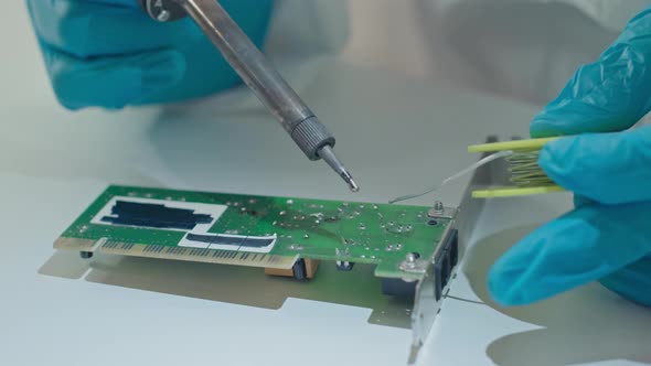 Engineer Soldering PCB in Laboratory alt