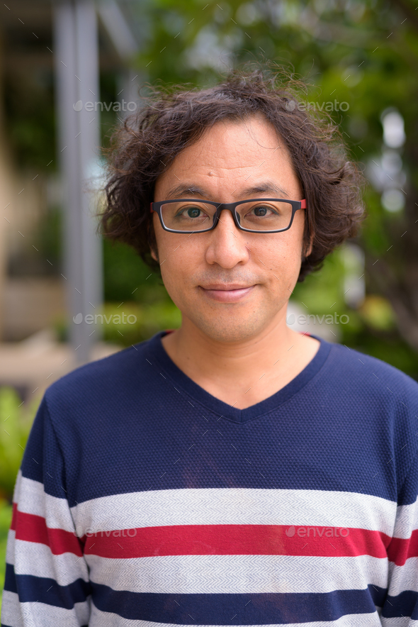 Face Of Japanese Man With Curly Hair Wearing Eyeglasses In The Rooftop Garden Stock Photo By Amazingmikael