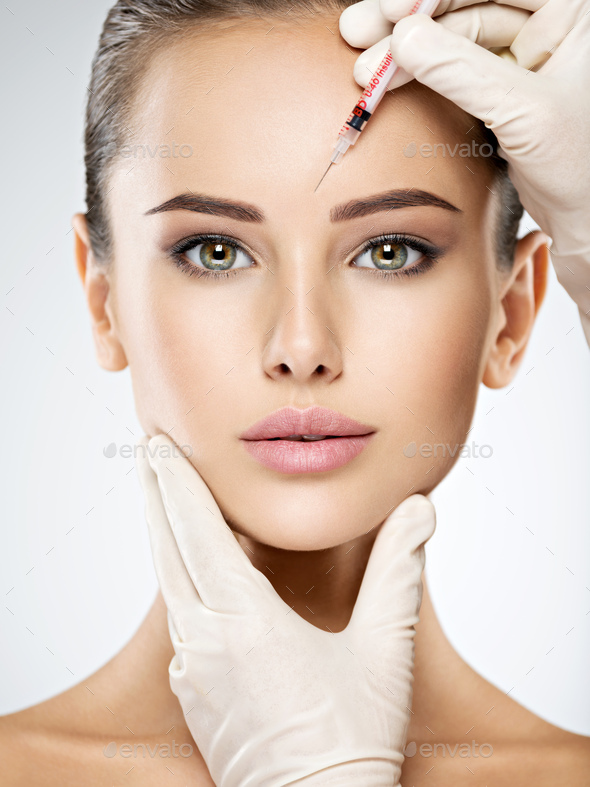 woman getting cosmetic botox injection in forehead Stock Photo by ...