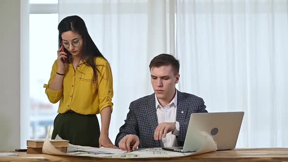 team of professional designers works in a bright office alt