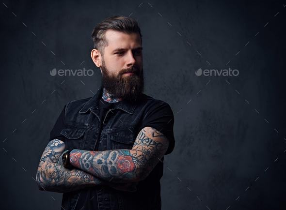 Studio portrait of bearded hipster male with tattoos on his arms. Stock  Photo by fxquadro