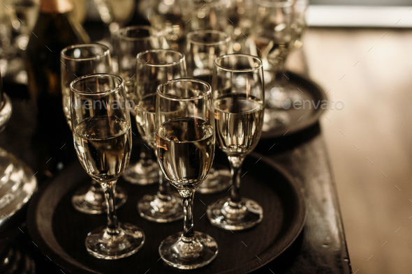 Luxury crystal champagne and wine glasses on dark wooden background