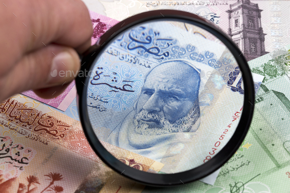 Libyan dinar in a magnifying glass - Stock Photo - Images
