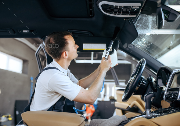 Woman wipes car interior with rag, hand auto wash Stock Photo by NomadSoul1