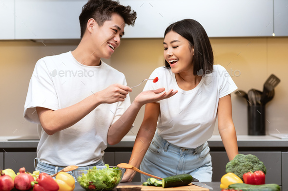 Asian family is cooking in the kitchen together