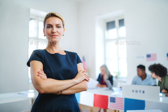 Front view portrait of confident woman voter in polling place, usa elections concept.