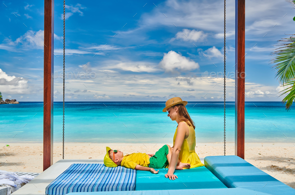 Mother with three year old boy on beach. Seychelles, Mahe. - Stock Photo - Images