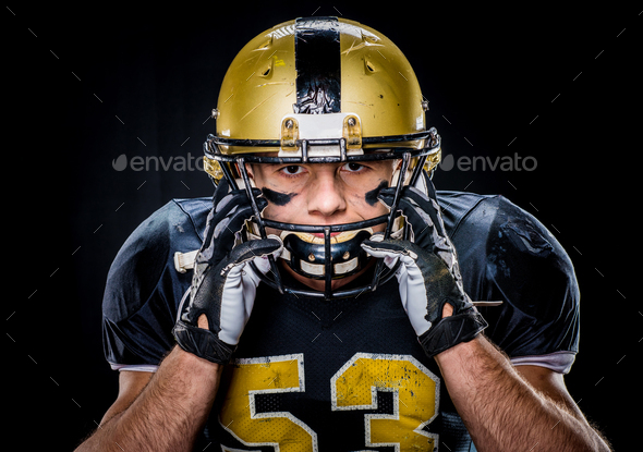 Close Up Portrait Of Muscular American Football Player In Uniform Adjusting Helmet Stock Photo By Lightfieldstudios